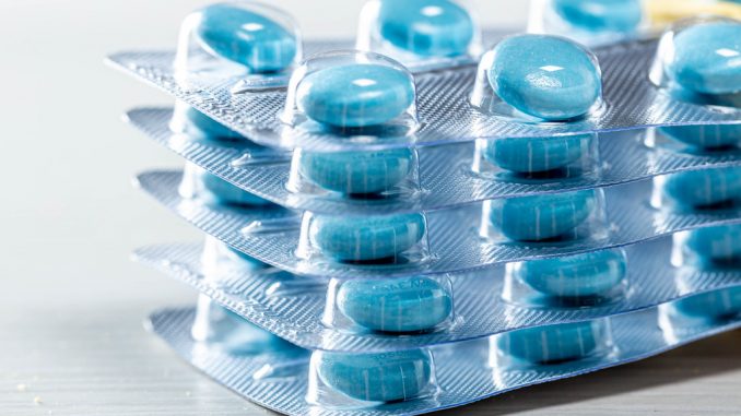 A stack of blue pills in the package close-up